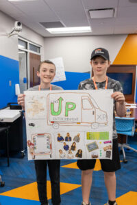 Students holding their posterboard presentation