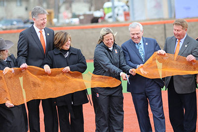 ribbon cutting fort wayne mayor tom henry and indiana tech softball coach stephanie zimny cut the ribbon to open Indiana Tech's new softball stadium